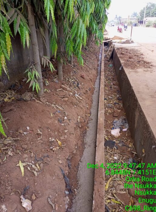 Freshly poured concrete along a narrow trench beside a drainage wall on Orba Road, Ihe Nsukka, Enugu State